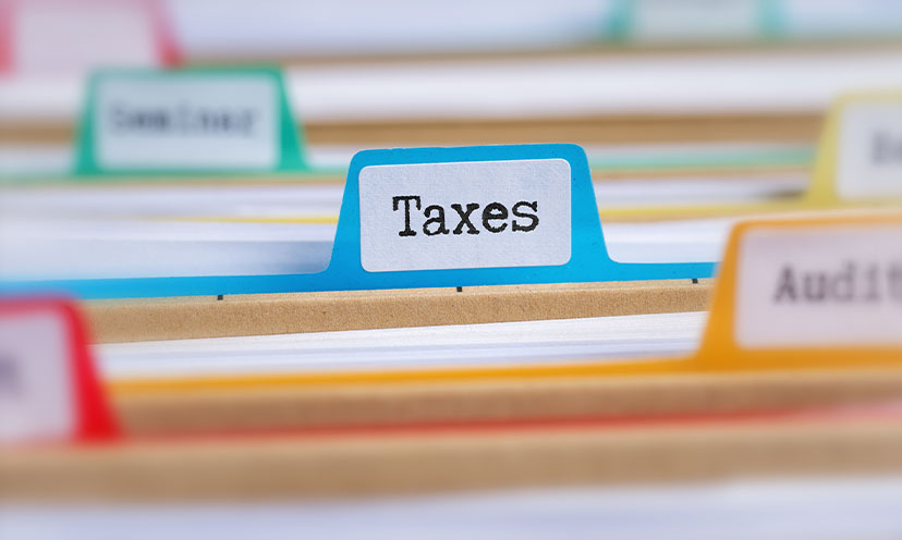 File folders with colorful tabs and one labeled "Taxes" in focus